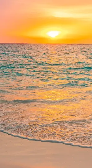 A sunset over the sea serves as a metaphor for the tranquility and joy that come from nurturing mental wellness, mirroring the serene beauty of this captivating scenery