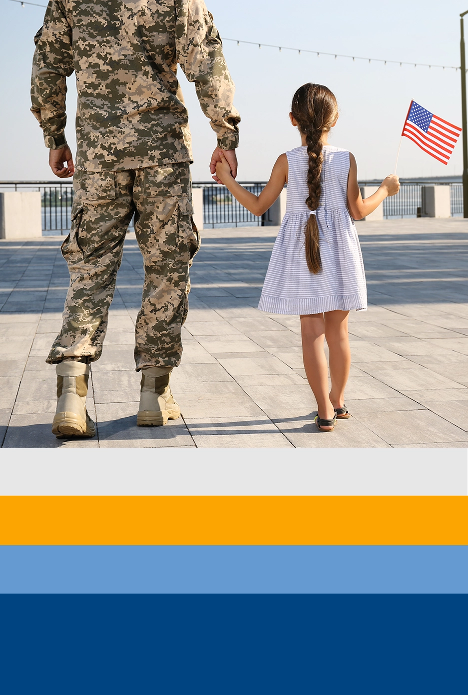 Military father holding hands with his young daughter, who clutches an American flag, exemplifies BTC's support for military veterans and their families